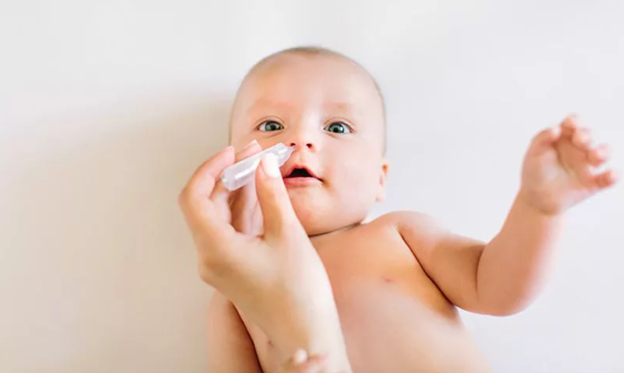Nhỏ nước muối sinh lý vào mũi của bé giúp thông thoáng mũi